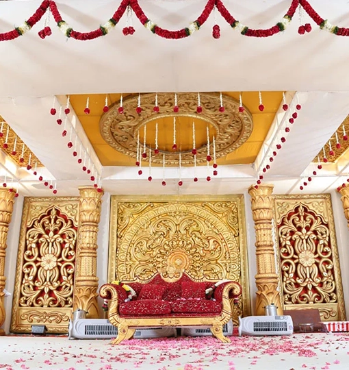 Stunning wedding ceiling decoration featuring flowers, fabrics and lighting for an elegant venue setting
