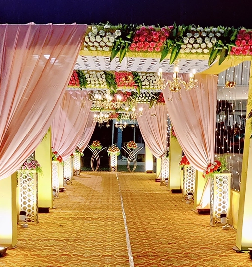 Elegant wedding entrance decoration with floral arrangements and stylish elements welcoming guests