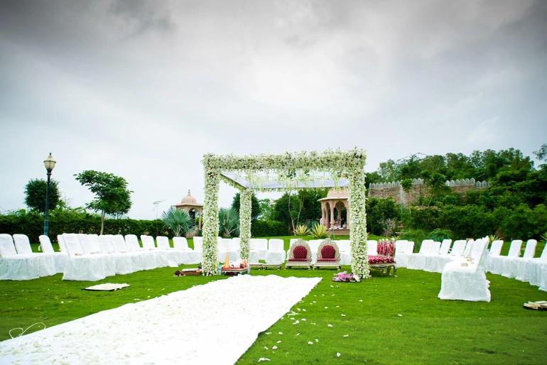  A destination wedding area decorated well with flowers, seating by best wedding event decor.