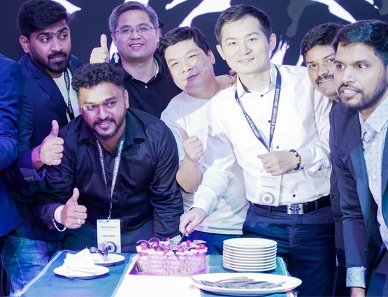 Cake cutting celebration at corporate employee get-together events capturing happy team bonding moments.