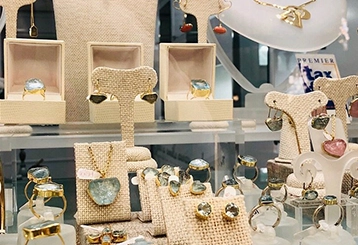 Expert stall designers creating custom displays for jewelry and accessories at trade shows to attract customers.