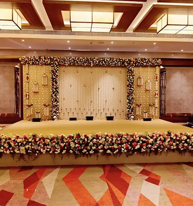 Bride and groom participating in a traditional wedding function with elegant event decor in Erode