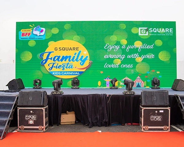 Professional team hosting a formal corporate event with seamless stage lighting and branding panels.