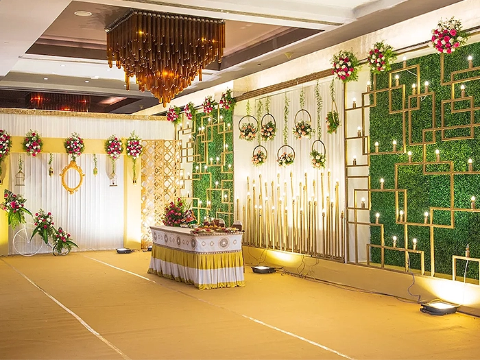 Luxury wedding decoration featuring elegant stage setup, lighting, and floral décor