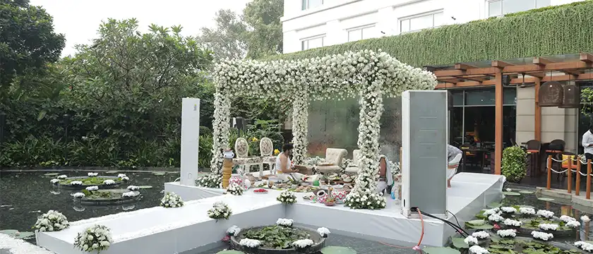 Outdoor wedding venue with decorative setup, seating and arrangements for celebrations in Erode