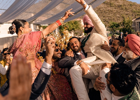 Grand wedding sangeet celebration with stage décor, lighting, and entertainment setup
