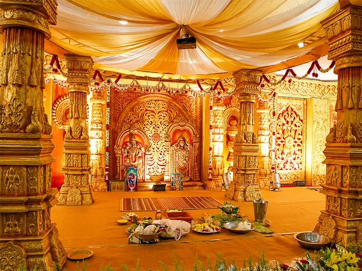 Beautifully decorated Brahmin wedding stage with floral arrangements and elegant ceremonial backdrop.